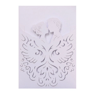 Detail showing white laser-cut wedding invitation with intricate silhouette and wings pattern