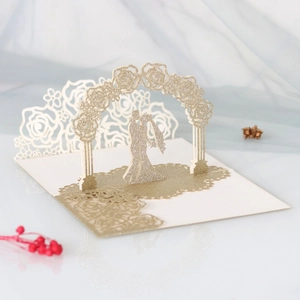 Detailed laser cut 3D wedding invitation featuring rose arch with golden glitter finish