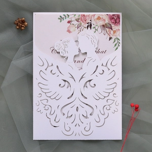 Detailed laser-cut wedding invitation featuring a kissing couple and floral insert card