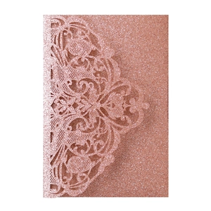 Detail of rose gold laser cut wedding invitation cover with elegant glitter floral patterns