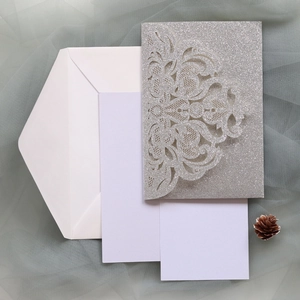 Detailed set of silver glitter laser-cut rose wedding invitations with envelopes
