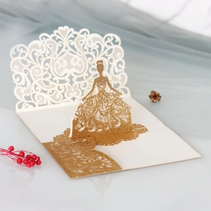 Macro view of laser-cut glitter gold pop-up card featuring an elegant bride design