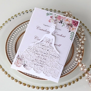 Detailed laser-cut wedding invitation featuring a floral dress girl design on a plate