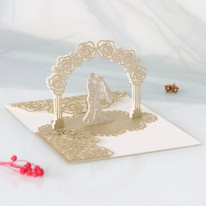 Detailed 3D laser cut wedding card with gold glitter flowers and romantic couple