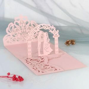 Detailed laser-cut 3D wedding invitation featuring a romantic couple under a floral arch