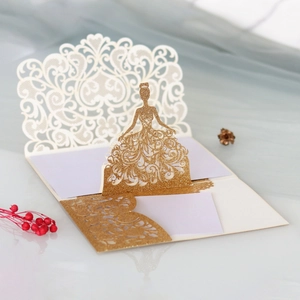 Detailed laser-cut 3D gold glitter wedding card featuring an elegant hollow gown design