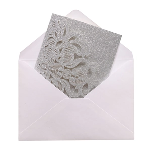 Silver laser-cut floral wedding invitation with glitter finish and a white envelope