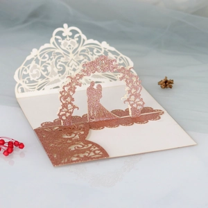 Detailed 3D pop-up wedding invitation with laser-cut rose gold glitter arch and silhouette
