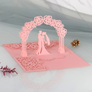 3D laser cut wedding card detail showing romantic rose arch and couple silhouette