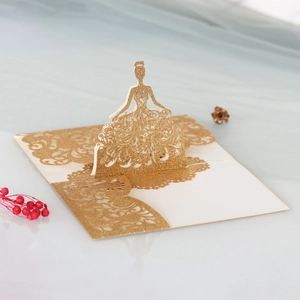 Detailed close-up of a 3D laser-cut gold glitter invitation with elegant girl pattern