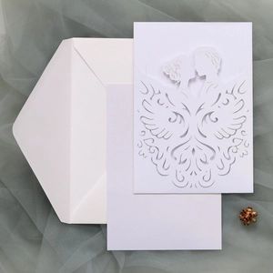 Detailed laser-cut wedding invitation set with white hollow sleeve and matching envelope
