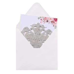 Detailed laser-cut silver glitter wedding invitation set with floral inner card and envelope
