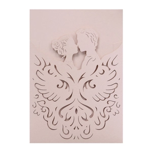 Laser cut light pink wedding invitation with kissing couple silhouette and scroll patterns