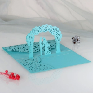 Detailed 3D laser-cut wedding invitation featuring a blue floral arch and bridal couple