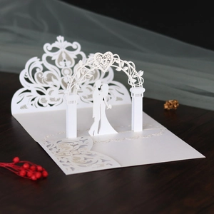 Detailed 3D laser cut wedding card showing a couple under a delicate floral archway