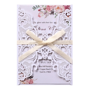 Lace laser cut wedding invitation with floral inner card and cream ribbon bow
