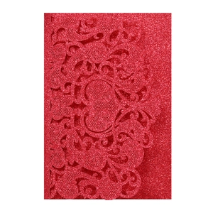 Macro detail of laser cut red glitter wedding invitation with European lace pattern