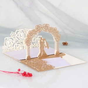 3D pop-up wedding card featuring laser-cut rose arch and kissing couple silhouette
