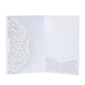 Detail of laser-cut lace floral pattern on high-quality white paper wedding invitation
