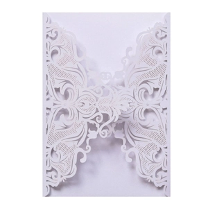 Close-up of laser cut hollow floral patterns on elegant white wedding invitation card