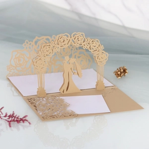 Close-up of laser-cut 3D pop-up wedding invitation with champagne rose silhouette
