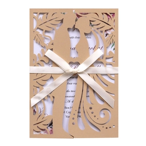 Detailed laser-cut lavender wedding invitation with intricate heart pattern and ribbon