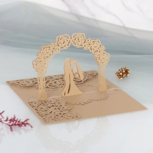 Detailed laser-cut 3D wedding invitation featuring a romantic rose arch and couple