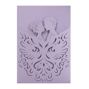Macro view of purple laser-cut wedding invitation with kissing couple and floral details