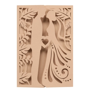 Close-up of laser-cut wedding invitation featuring a romantic couple silhouette