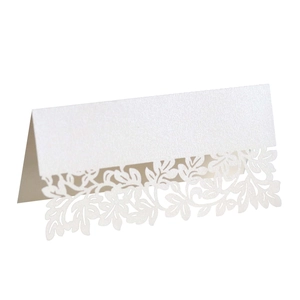 Detailed laser-cut leaf pattern on white pearlescent paper wedding place cards