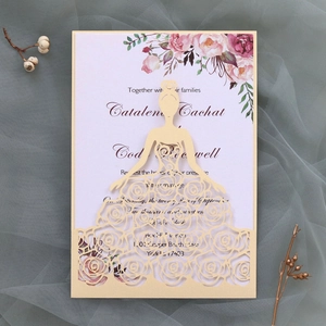 Detail of laser-cut bridal dress wedding invitation with floral printed inner card