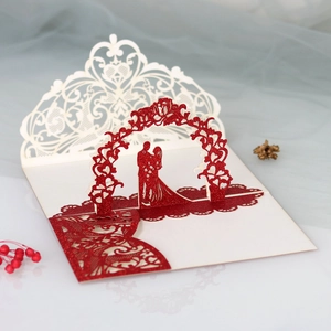 Macro view of 3D pop-up wedding invitation featuring laser-cut rose and couple silhouette