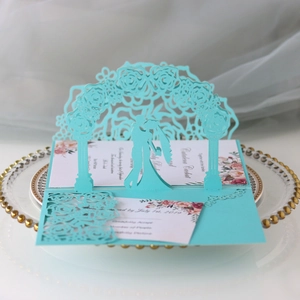 Detailed laser-cut Tiffany blue 3D wedding invitation with floral arch and couple silhouette