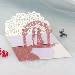 Detail of 3D pop-up wedding invitation featuring laser-cut rose patterns and glitter finish
