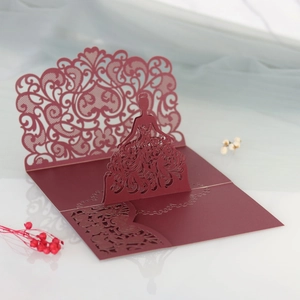 Detail of 3D laser-cut lace girl silhouette on burgundy wedding invitation card
