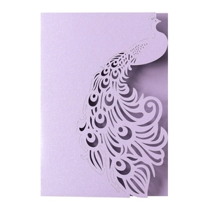 Detailed laser-cut peacock pattern on lavender pearlescent paper wedding card