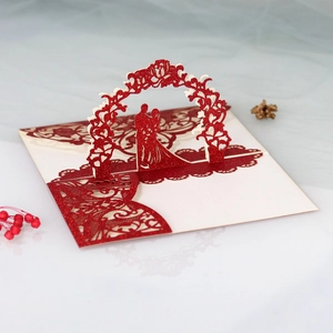 Detail of red glitter 3D pop-up wedding invitation card with laser-cut bride and groom