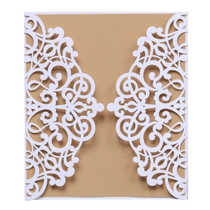 Macro detail of laser-cut white invitation shell with intricate floral hollowed patterns