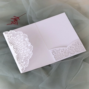 Intricate laser-cut lace invitation card shell in white pearlescent paper on elegant tulle
