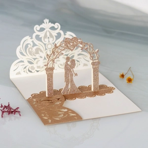Detailed 45-degree macro view of 3D laser-cut wedding invitation with rose gold glitter
