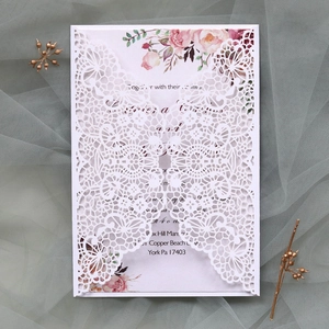 Détail d'invitation de mariage en dentelle découpée au laser avec carte florale rose