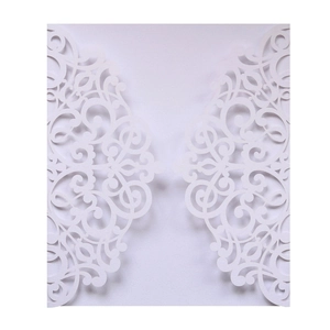 Detail of laser-cut hollow butterfly wedding invitation with elegant white lace patterns