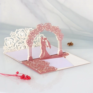 Detail of 3D rose gold glitter pop-up wedding invitation card with laser cut floral arch