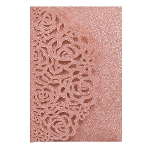 Close-up of laser-cut rose floral hollow design on rose gold glitter invitation cover