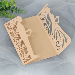 Detailed laser-cut wedding invitation cover with champagne gold pearl finish and couple design