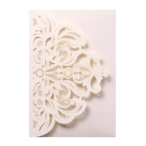 Detailed laser-cut pattern on cream pearl paper wedding invitation with floral lace