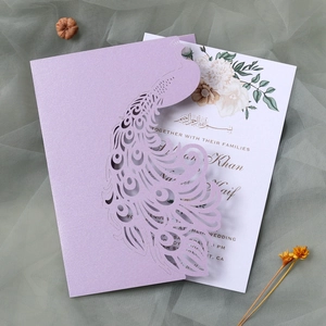 Elegant laser-cut peacock wedding invitation set with pearlized lavender cover and floral inner