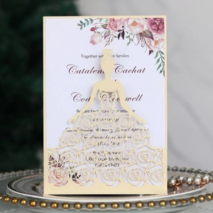 Detail of laser-cut wedding invitation featuring rose dress silhouette and floral insert