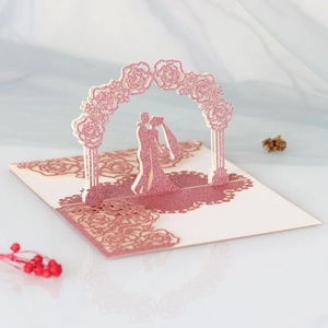 Macro view of 3D pop-up wedding card featuring laser-cut rose arch and glitter finish