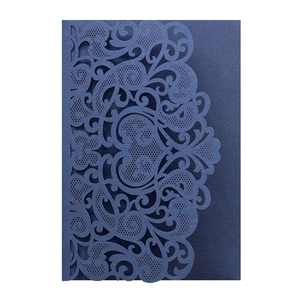 Detailed laser-cut navy blue wedding invitation card with intricate lace floral patterns